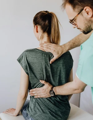 Person legt einer anderen Person die Hand auf den R&uuml;cken